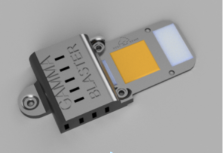 Close-up of a metallic mini blaster device with a yellow component.