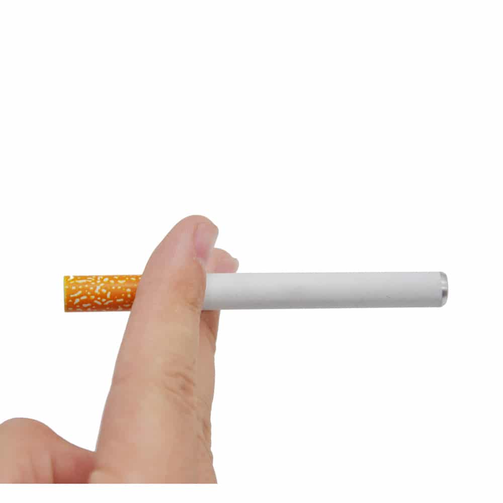 Hand holding a cigarette against white background.