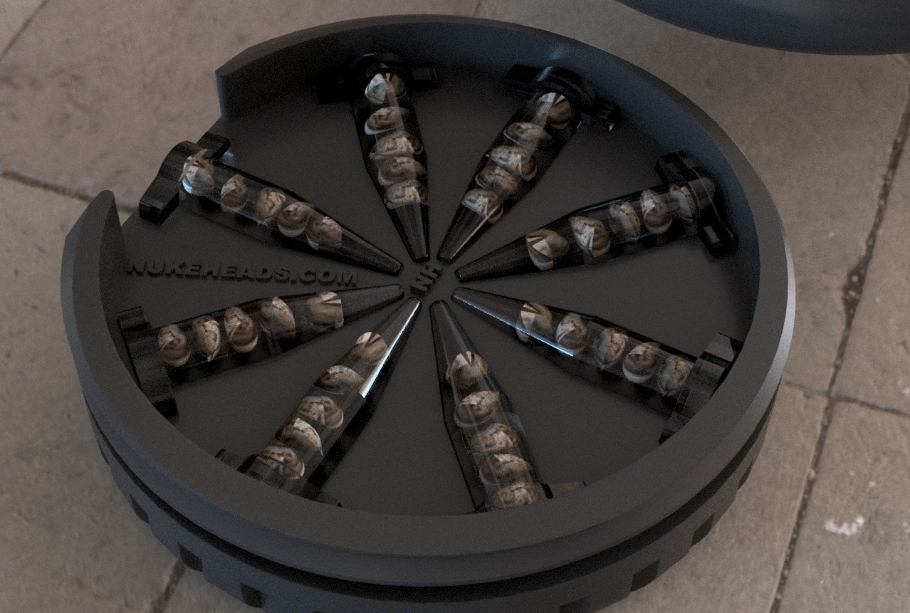 Close-up of a black circular device with multiple metal spikes arranged radially.